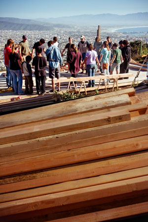 The construction team prays.  © Jessica Fairchild